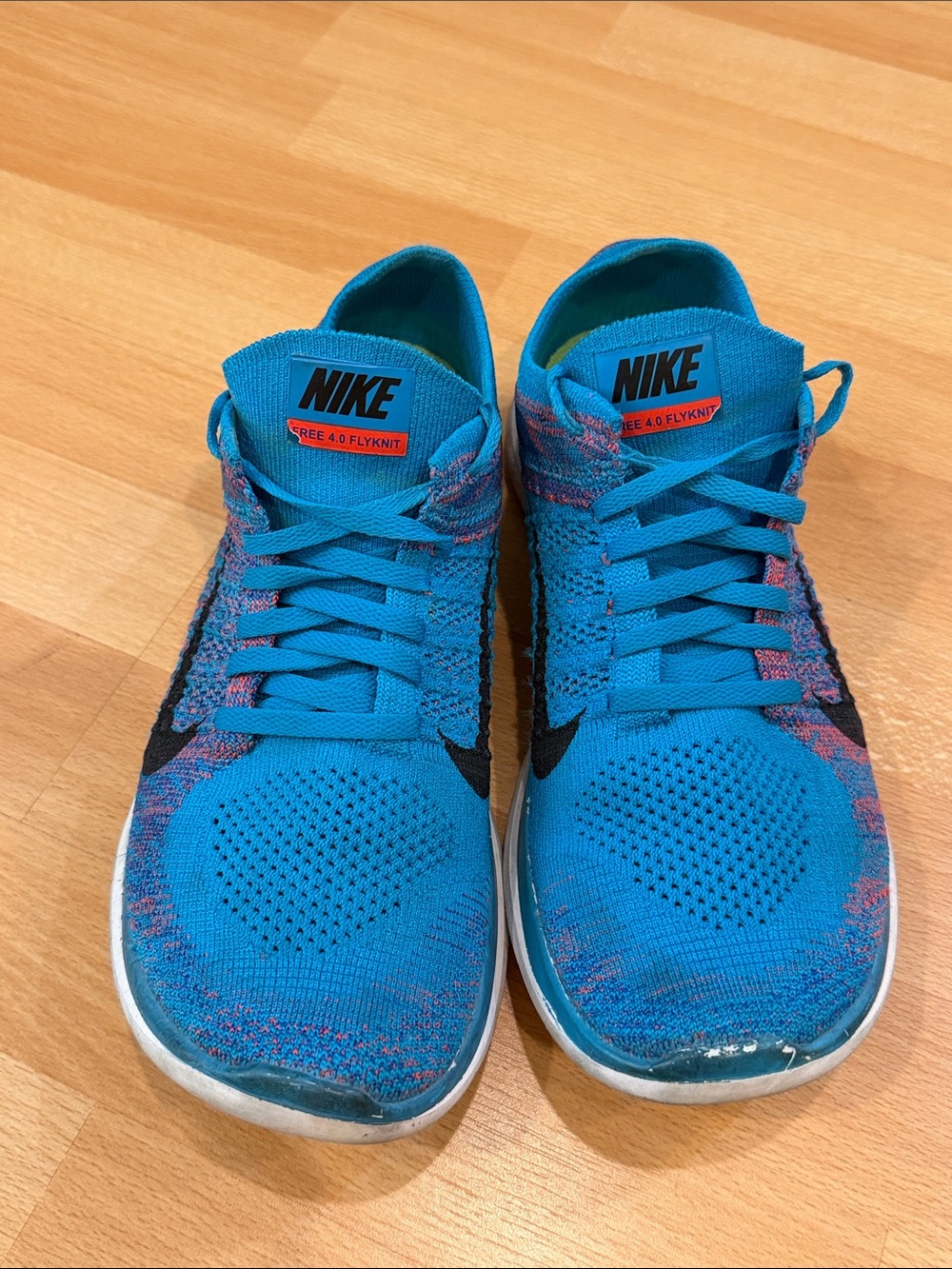 Nike Men’s Turquoise Flyknit Athletic Shoes with Pink Accents